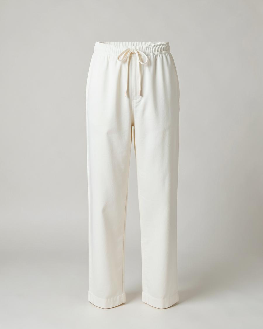 Ivory drawstring pyjama trousers photographed against a plain studio backdrop
