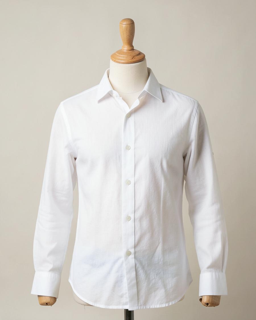 White cotton shirt on a headless tailor mannequin against a plain studio backdrop